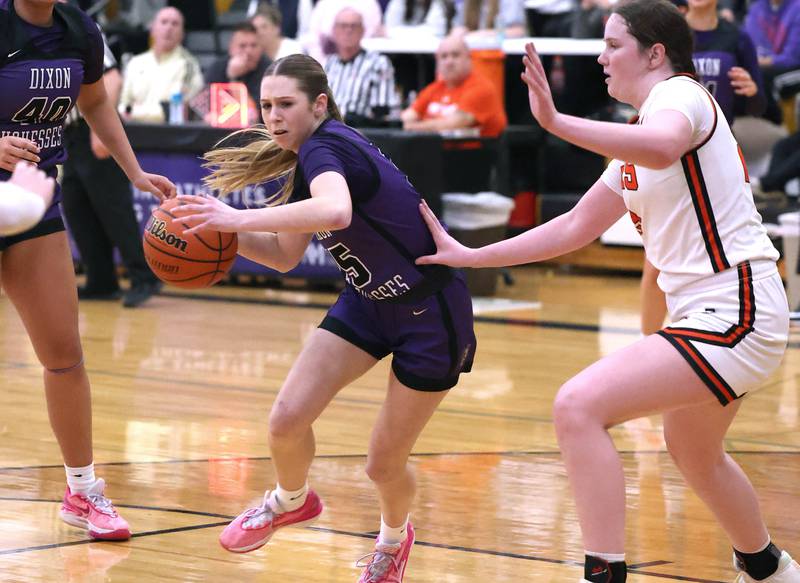 Dixon’s Morgan Hargrave drives past Crystal Lake Central's Leah Spychala during their Class 3A sectional semifinal Tuesday, Feb. 20, 2024, at Sycamore High School.