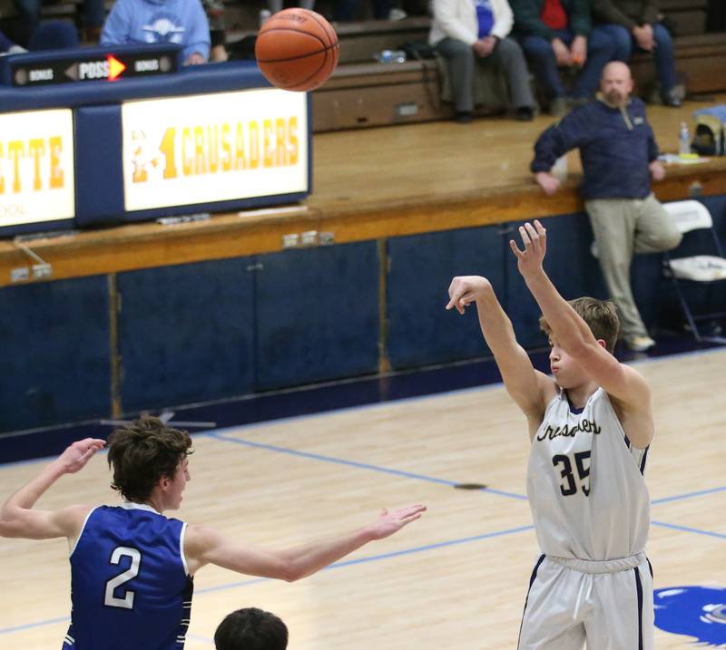 Marquette's Peter McGrath shoots a three point shot over Newark's Cole Reibel on Tuesday, Jan. 10, 2023 in Bader Gymnasium at Marquette High School.