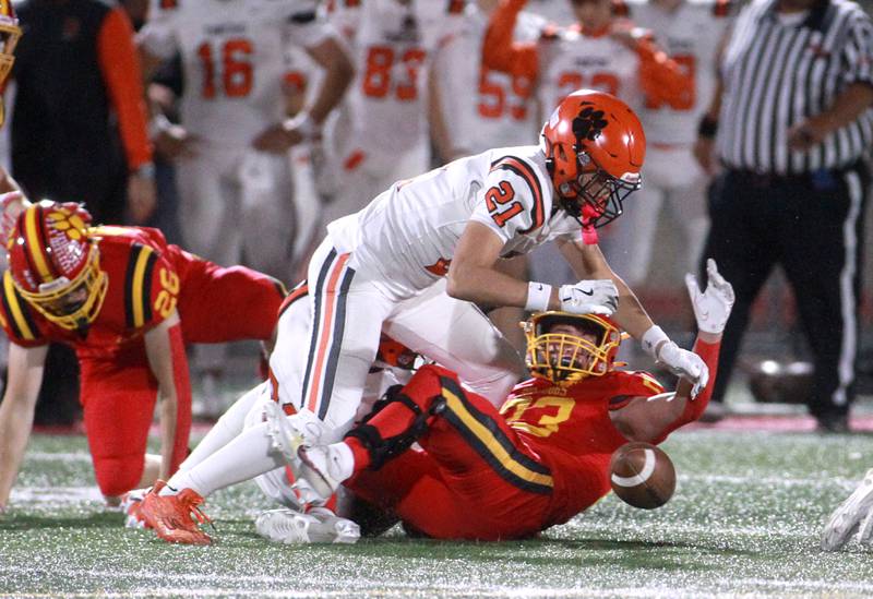 Wheaton Warrenville South’s Brady McClatchy (left) and Batavia’s Josh Kahley (right) go after the loose ball after it was stripped by Batavia on Friday, Oct. 18, 2024 during a game at Batavia.