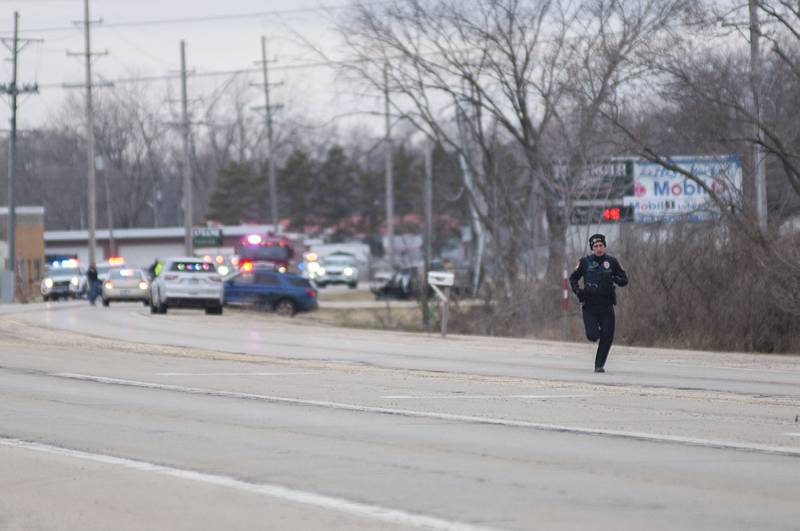 A Rock Falls police officer heads back to his squad while working at the scene of an accident on east Route 30 on Tuesday, March 29 2022.