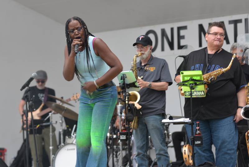 Brass from the Past's Regina Rhymes of Chicago sings to the large crowd at the opening night of the  Jamboree music series in downtown Mt. Morris on Friday, June 7, 2024. The free concert series continues through the summer each Friday night on the campus.