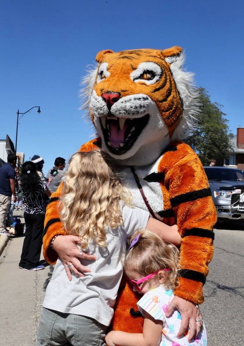 A tiger mascot hugs kids during the Homestead Festival on Saturday, Sept. 7,, 2024 in Princeton.