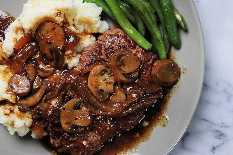 Salisbury steak with mushroom gravy and mashed potatoes is old-school comfort food at its best.