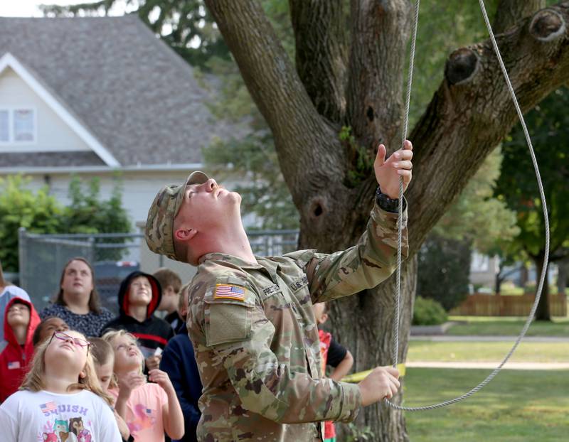 Army Pvt. Damien M. Presthus and La Salle County Sheriff's raise an American Flag during a 9/11 Memorial Service on Wednesday, Sept. 11, 2024 at Circuit Breaker School in Peru. Firefighters police officers and paramedics from La Salle, Peru, and Hennepin participated in the memorial service.