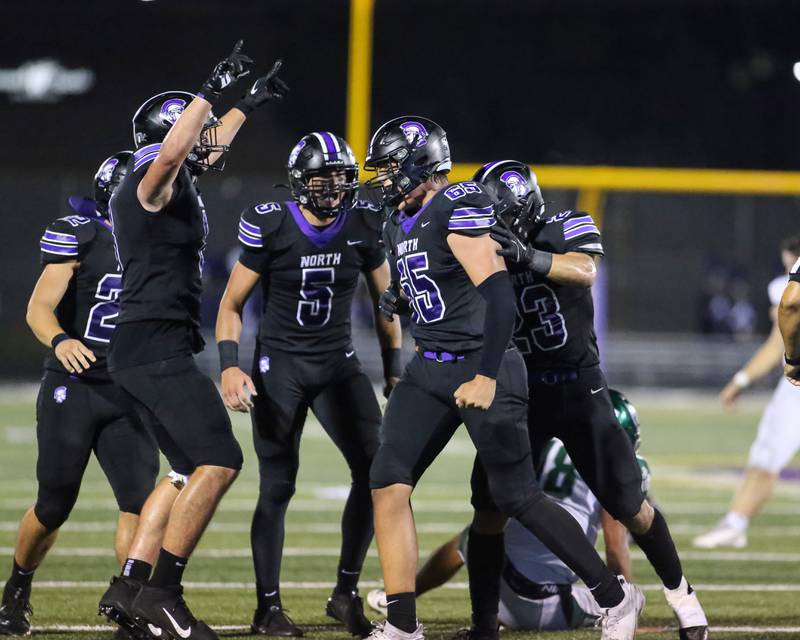 Downers Grove North's Aiden Solecki (65) celebrates a sack with teammates during a football game between Glenbard West at Downers Grove North on Friday, Sept 13th, 2024  in Downers Grove.