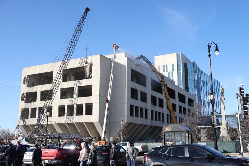 A wreaking ball and claw begin working on the external demolition of the old Will County Courthouse on Friday, Feb. 9th 2024 in Joliet.