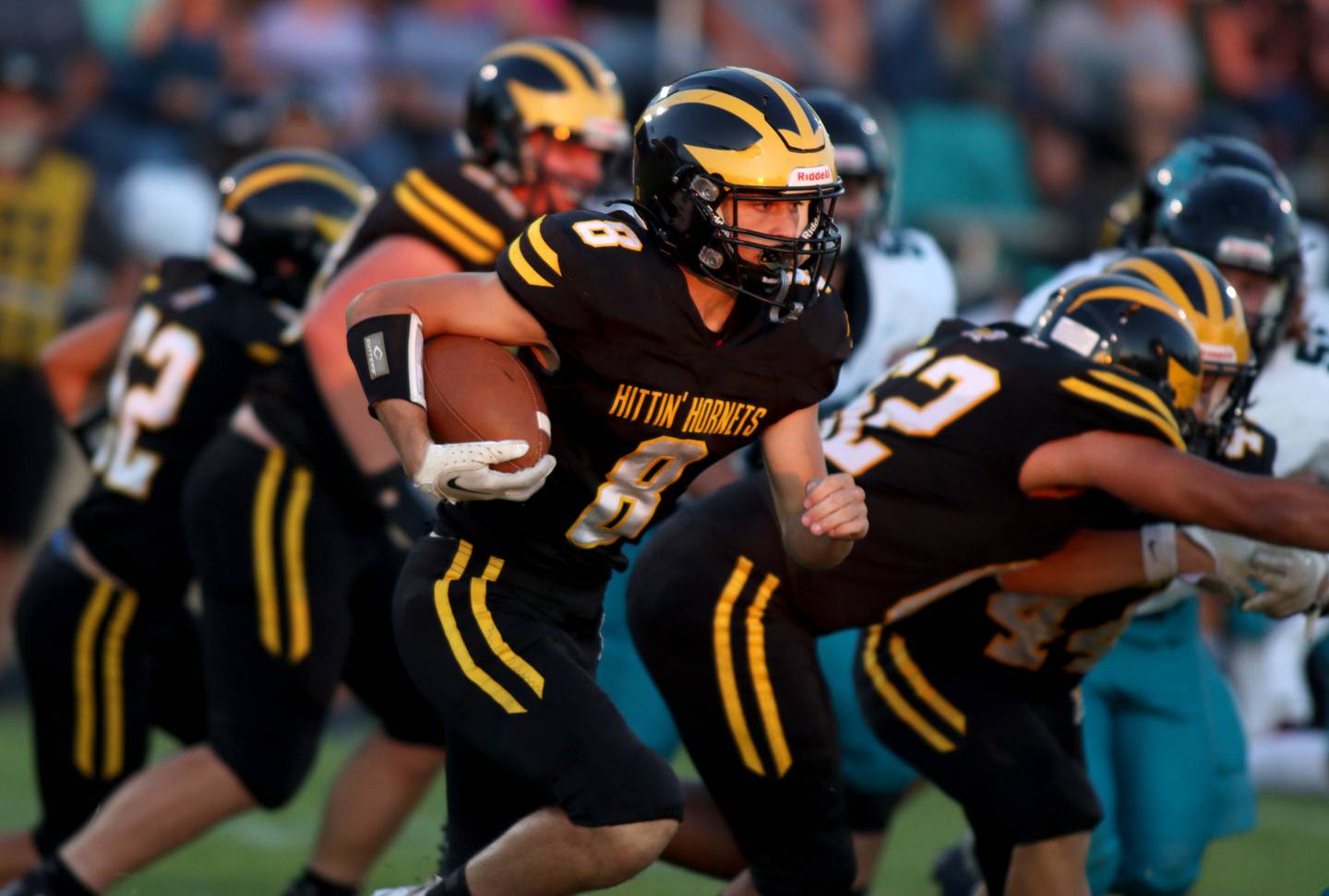 Harvard’s Adam Cooke moves the ball against Woodstock North in varsity football at Harvard Thursday night.