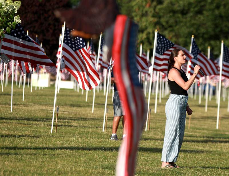 Annie Ittersagen sings the Star Spangled Banner during the opening night of the Field of Honor at Seven Gables Park in Wheaton on Saturday, June 29, 2024.