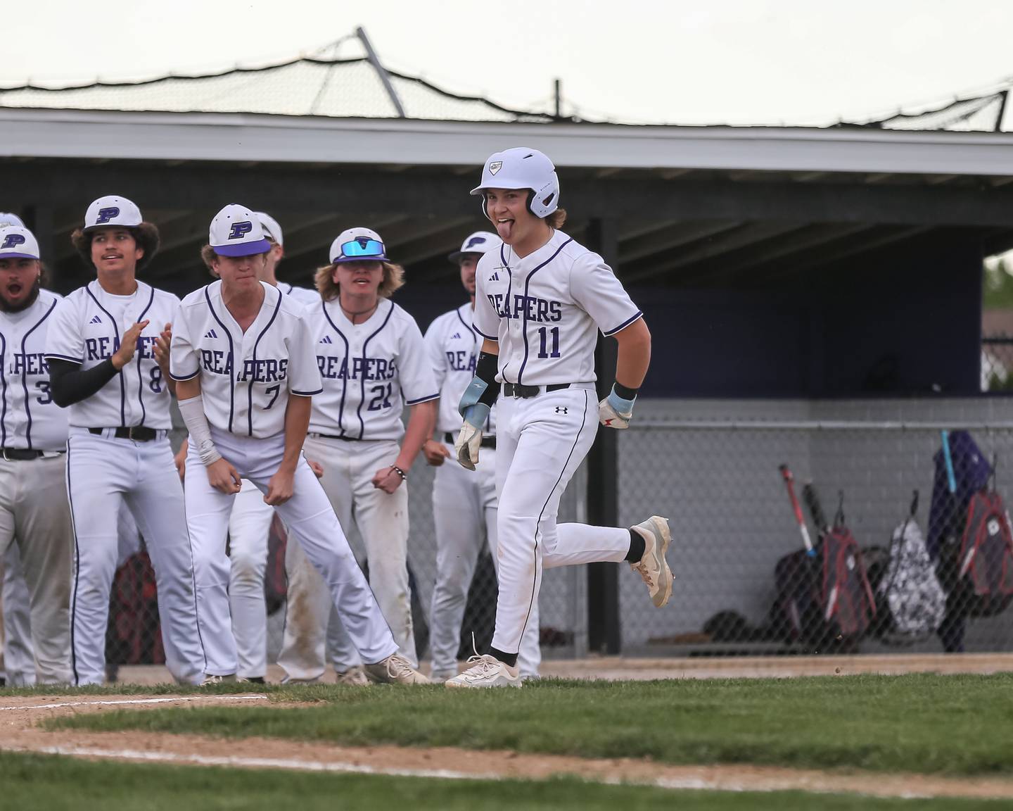Plano's Nick Serio (11) is greeted at the plate after hitting a homerun during baseball game between Sandwich at Plano.  May 8, 2024