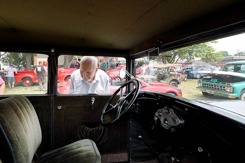 Ed Jacobsen checks out the interior of a ’31 Ford Friday, June 23, 2023 on the grounds of Franklin Grove Assisted Living during a car show event. Residents and staff decorated wooden cars which were voted for online as a fun contest. The car is being raffled off by Farming Heritage Inc. to help fund the 1860 H.I. Lincoln building which is home to the Lincoln Highway Associations National Interpretive Center. For more info on the raffle call the center at 815-456-3030.