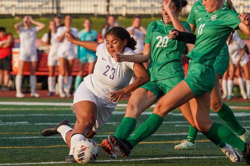 Downers Grove North's Kaitlyn Parker (23) shoots the ball against three York defenders during a Class 3A Hinsdale Central Sectional semifinal soccer match at Hinsdale Central High School in Hinsdale on Tuesday, May 21, 2024.