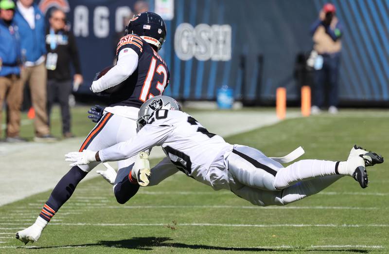 Chicago Bears wide receiver Tyler Scott tries to run ahead of Las Vegas Raiders safety Isaiah Pola-Mao during their game Sunday, Oct. 22, 2023, at Soldier Field in Chicago.