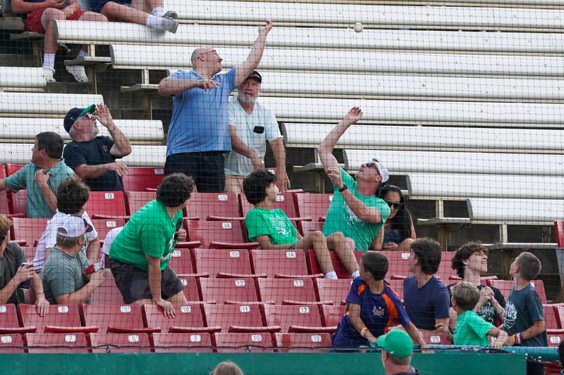 York fans try to catch a foul-ball in the stands during a class 4A Kane County supersectional baseball game against McHenry at Northwestern Medicine Field in Geneva on Monday, June 3, 2024.