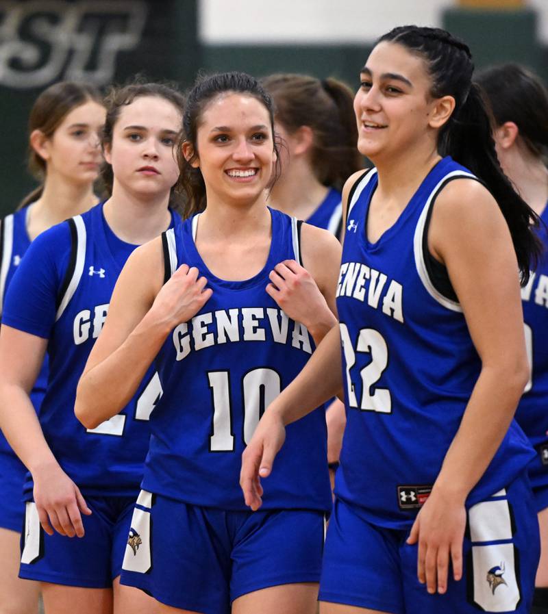 Geneva players including Peri Sweeney, (10) and Leah Palmer (22) celebrate their 45-32 victory over Glenbard West during the Glenbard West Class 4A girls basketball regional final on Thursday, Feb. 15, 2024 in Glen Ellyn.