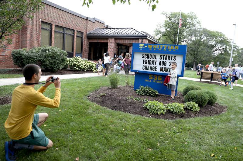 James Lenihan takes a photo of his kindergartner son, James, on the first day of school at Whittier Elementary School in Downers Grove on Friday, Aug. 25, 2023.