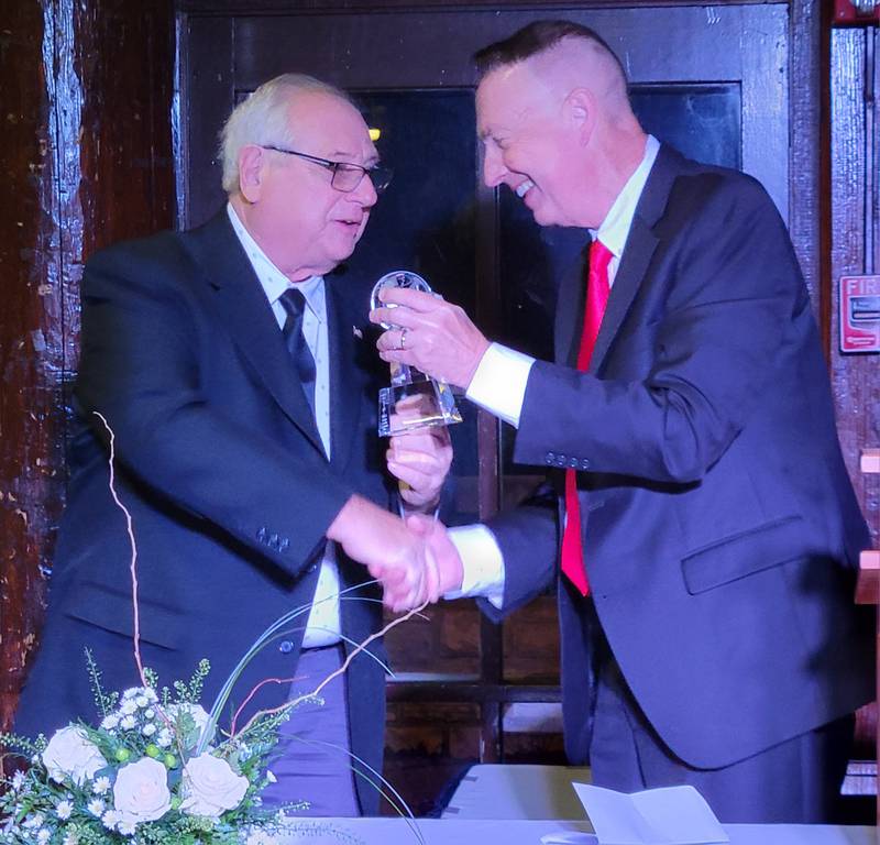 Longtime Ottawa Commissioner Wayne Eichelkraut (left) accepts the Leo Parkerson Award for lifetime achievement from Ottawa Area Chamber of Commerce interim executive director Jay McCracken on Thursday at Starved Rock Lodge.