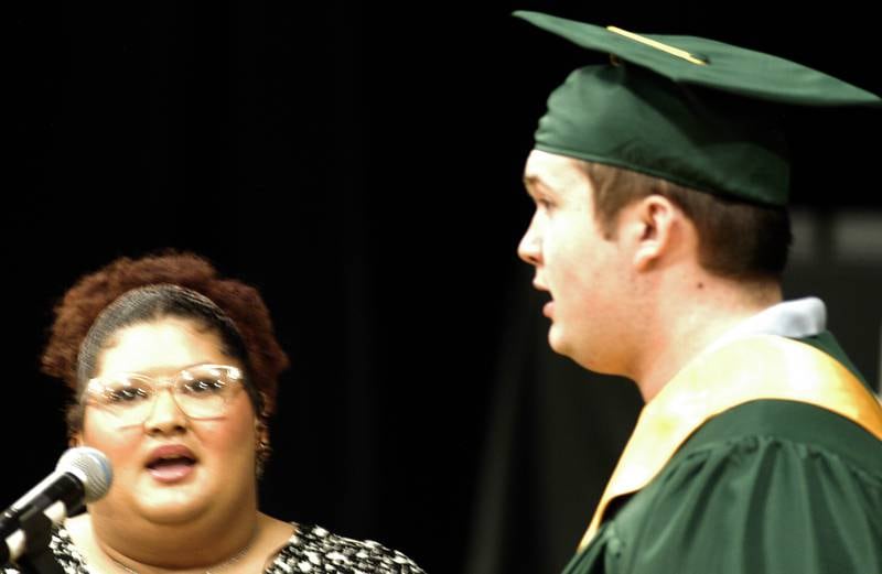 Alliah Haines-Perry and Branden Thome sing the national anthem to begin the graduation ceremony Sunday, May 26, 2024, at Tabor Gym at Rock Falls High School.