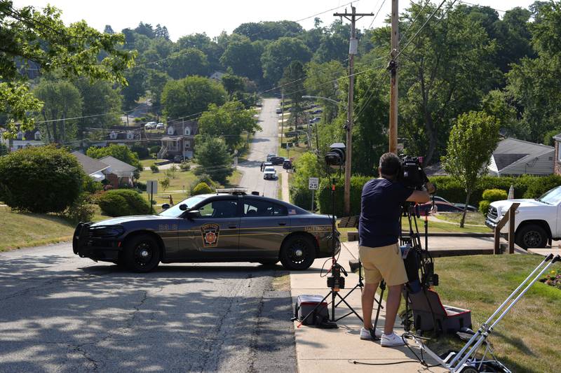 Law enforcement block a street in Bethel Park, Pa., that they say is near a residence of Thomas Matthew Crooks, the suspected shooter of former President Donald Trump, Sunday, July 14, 2024. (AP Photo/Joshua A. Bickel)