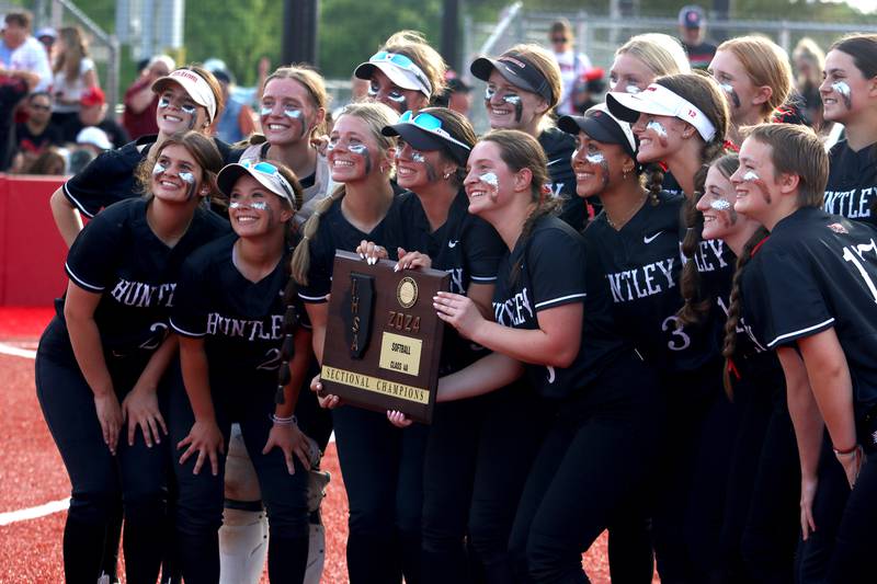 Huntley’s Red Raiders celebrate a win over Barrington in sectional final softball action at Barrington Friday.