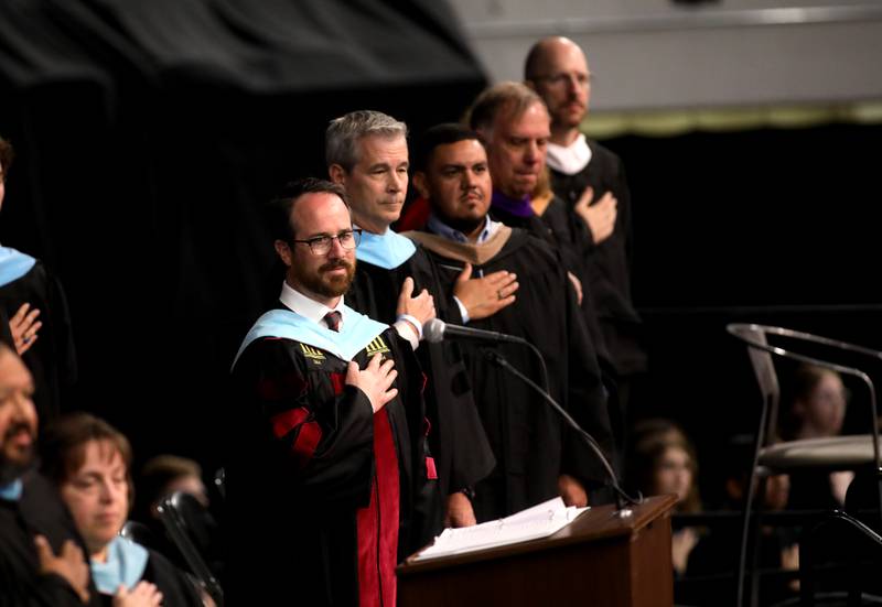 Kaneland High School Principal James Horne and Kaneland School District 302 Superintendent Todd Leden say the National Anthem during the school’s 2024 Commencement Ceremony at Northern Illinois University in DeKalb on Sunday, May 19, 2024.