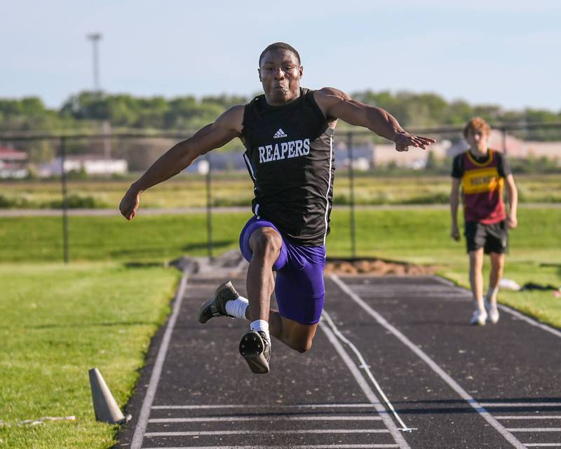 Waleed Johnson of Plano competes in the triple jump during the Kishwaukee River Conference track meet held at Plano High School.