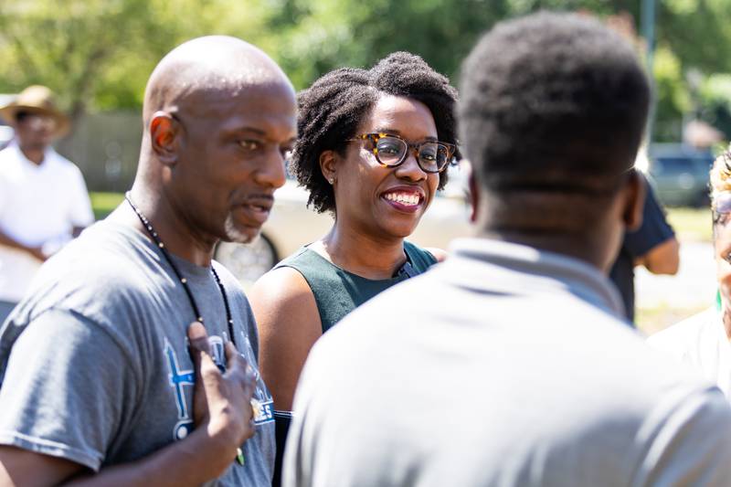 U.S. Representative Lauren Underwood chats with History on Wheels Founder Luther E. Johnson Jr. (Left) and his son Christian Johnson during the groundbreaking ceremony and Juneteenth celebration at the African Descendants Military and Historical Museum in Joliet on June 19, 2024.