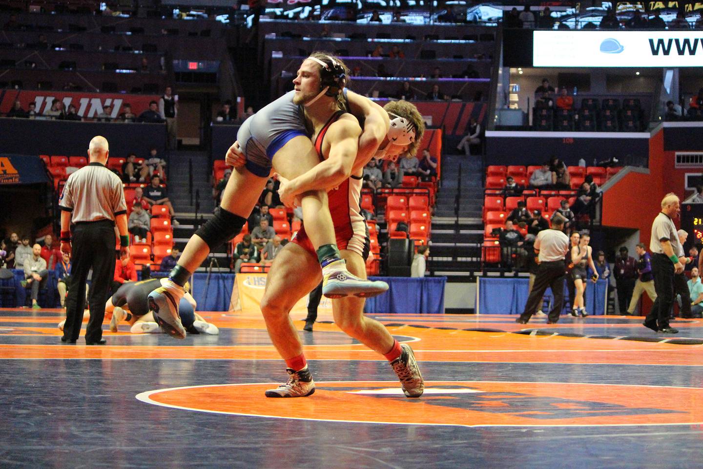 Erie-Prophetstown's Jase Grunder lifts his opponent during a 152-pound bout in the first round at the IHSA Individual State Finals on Thursday, Feb. 16, 2023 at State Farm Center in Champaign.