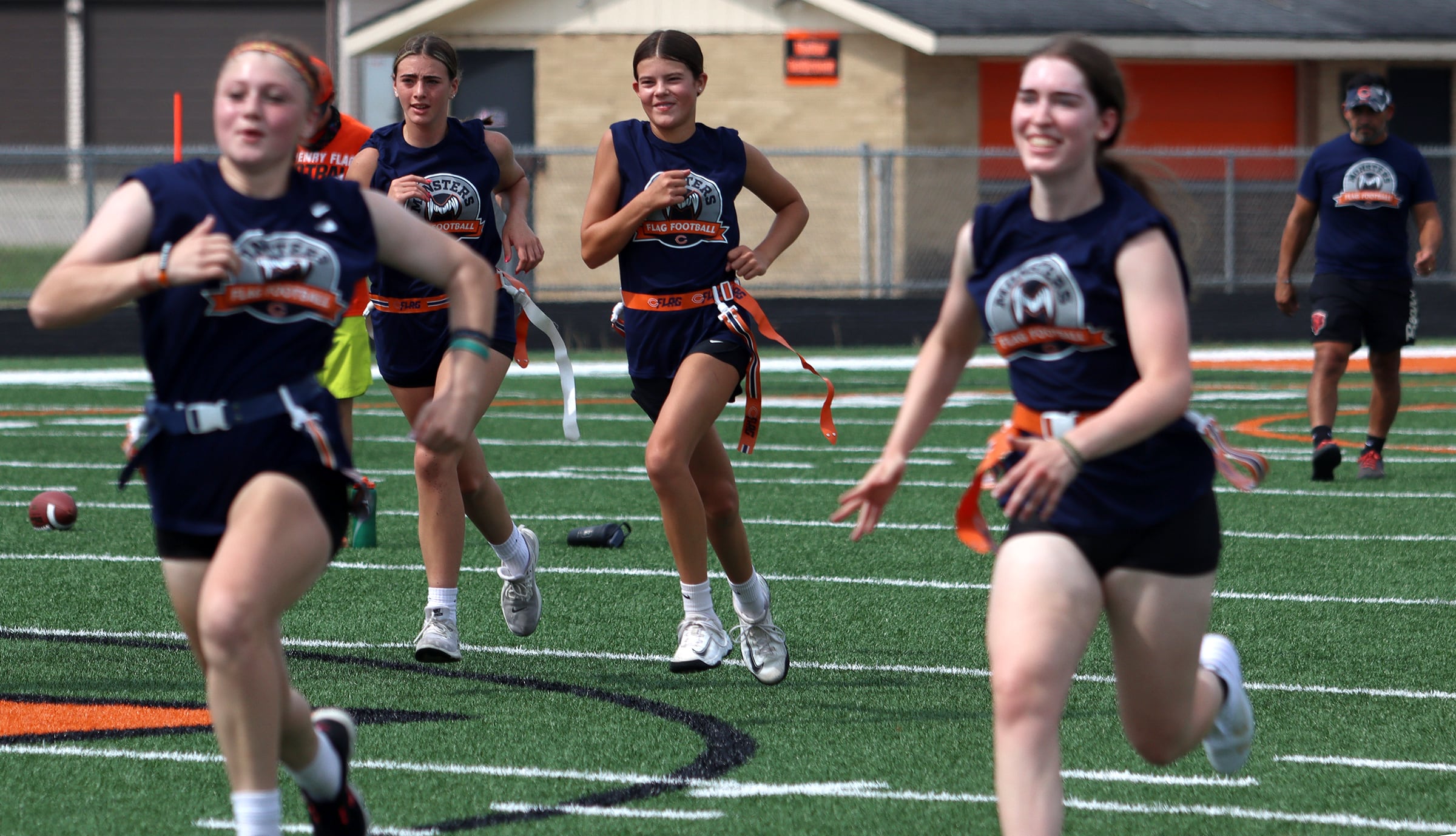 Athletes hustle between drills as the Chicago Bears and McHenry Community High School hosted a flag football clinic at McCracken Field Wednesday.