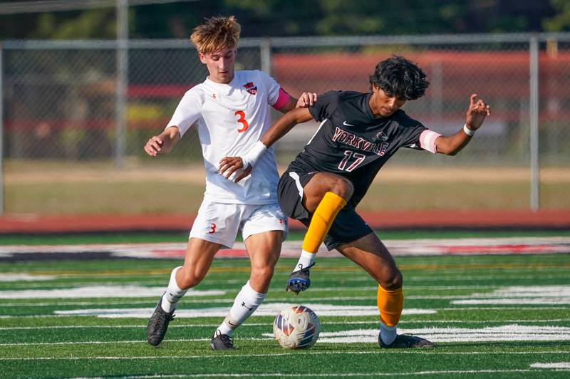 Oswego’s Kevin Laird (3) challenges Yorkville's Joseph Kallan (17) for the ball during a soccer match at Yorkville High School on Tuesday, Sep 17, 2024.