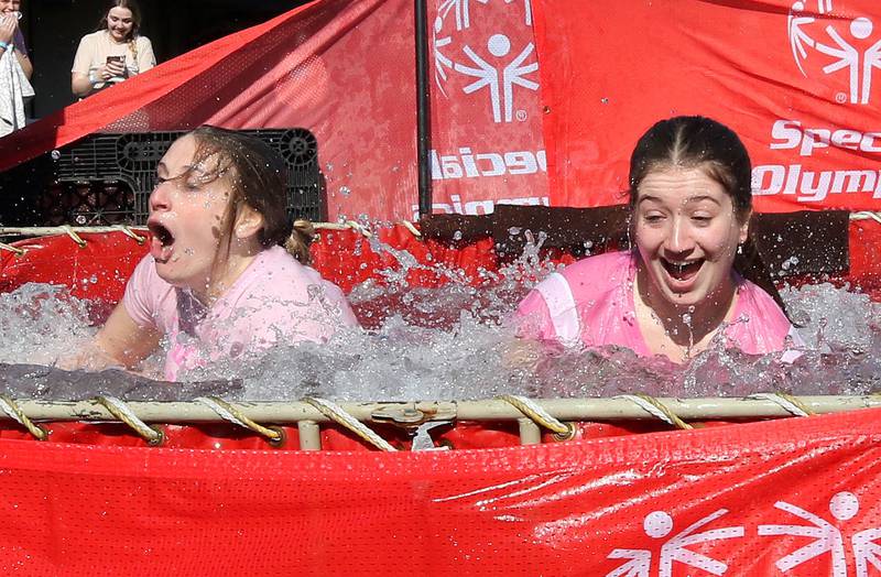 Members of the Alpha Sigma Alpha sorority emerge from the water on a cold and windy Saturday, Feb 17, 2024, during the Huskie Stadium Polar Plunge at Northern Illinois University in DeKalb. The Polar Plunge is the signature fundraiser for Special Olympics Illinois.