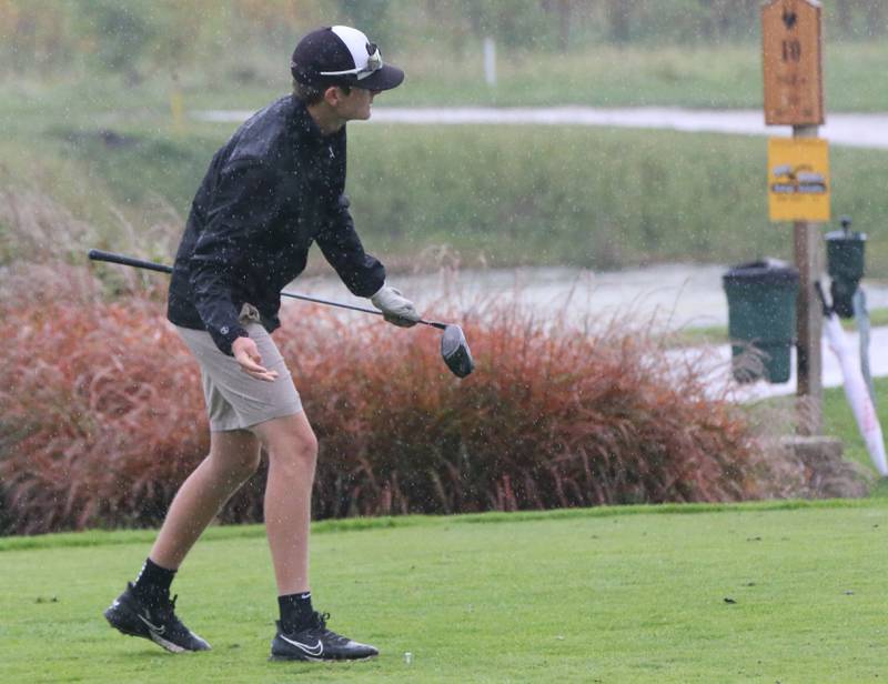 Woodland's Tucker Hill tees off in the pouring rain during the Class 1A Regional on Wednesday, Sept. 27, 2023 at Wolf Creek Golf Club in Pontiac.