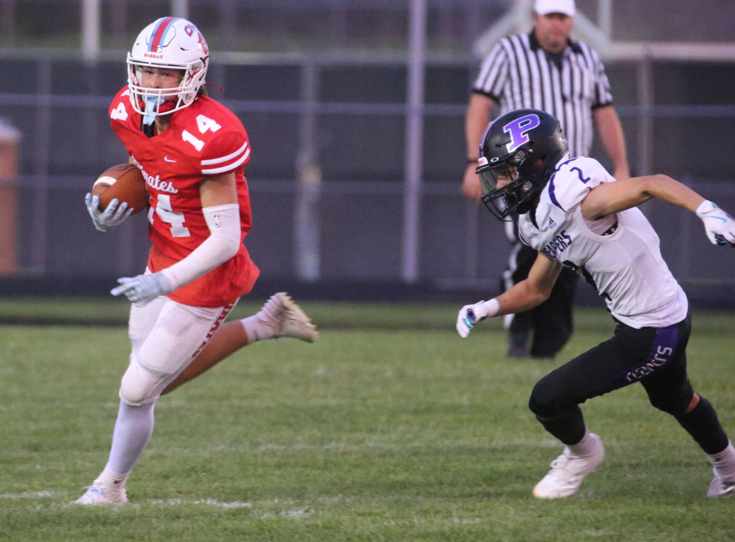 Ottawa's Archer Cechowicz carries the ball as Plano's Tristan Meszaros chases after him on Friday, Aug. 30, 2024 at King Field.