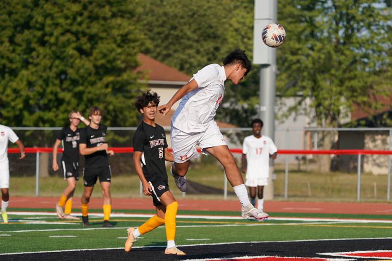 Oswego’s Israel Cortez Jr (24) goes up for a header against Yorkville's Andres Esparza (5) during a soccer match at Yorkville High School on Tuesday, Sep 17, 2024.