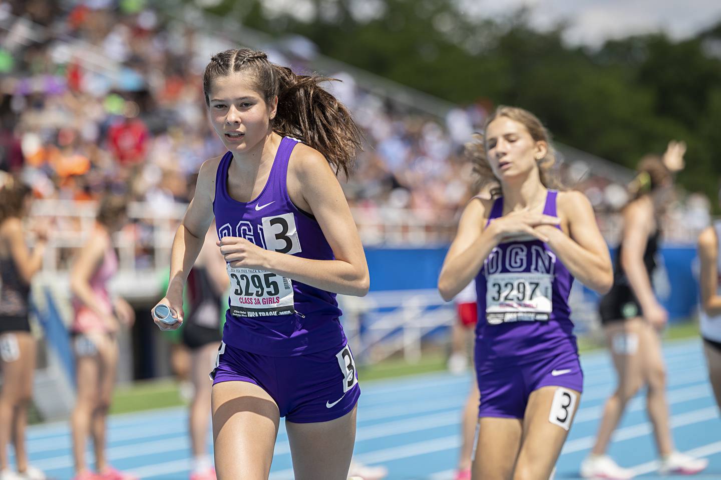 Downers Grove North’s Lily Eddington takes the baton in the 3A 4x800 Saturday, May 18, 2024 at the IHSA girls state track meet in Charleston.