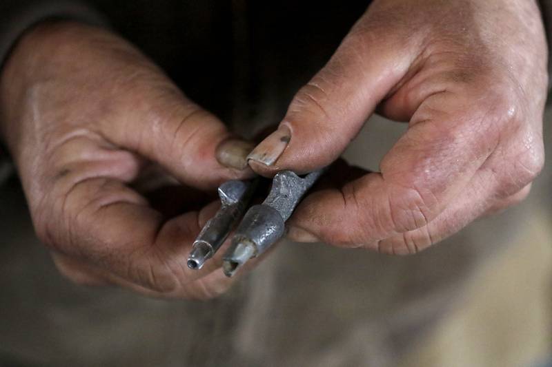 Chuck Howenstine holds two sizes of spiles used to collect maple on Thursday, March 9, 2023, at the Pioneer Tree Farm in McHenry. He has been collecting sap for most of his adult life to make maple syrup that he gives away.