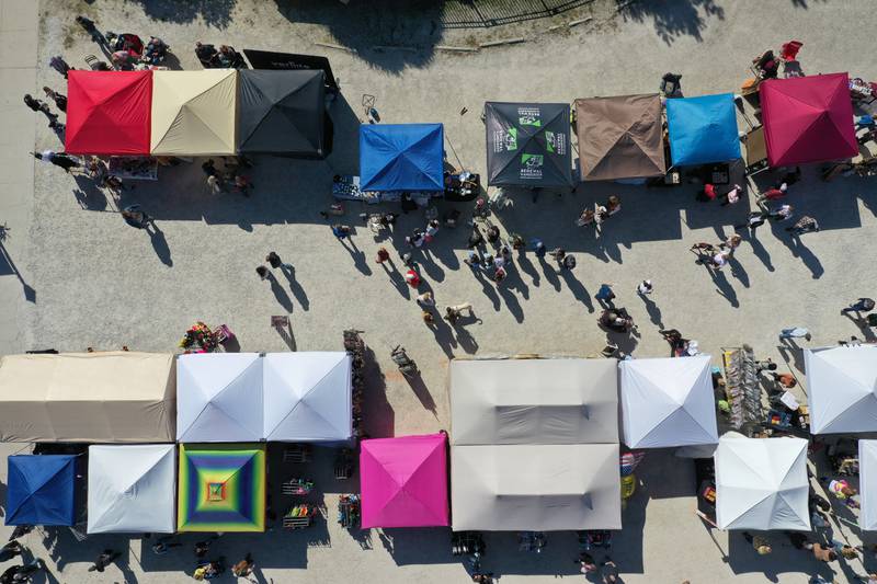 Colorful tents and vendors welcome visitors along Church Street downtown Utica for the 52nd annual Burgoo Festival on Sunday, Oct. 9, 2022.