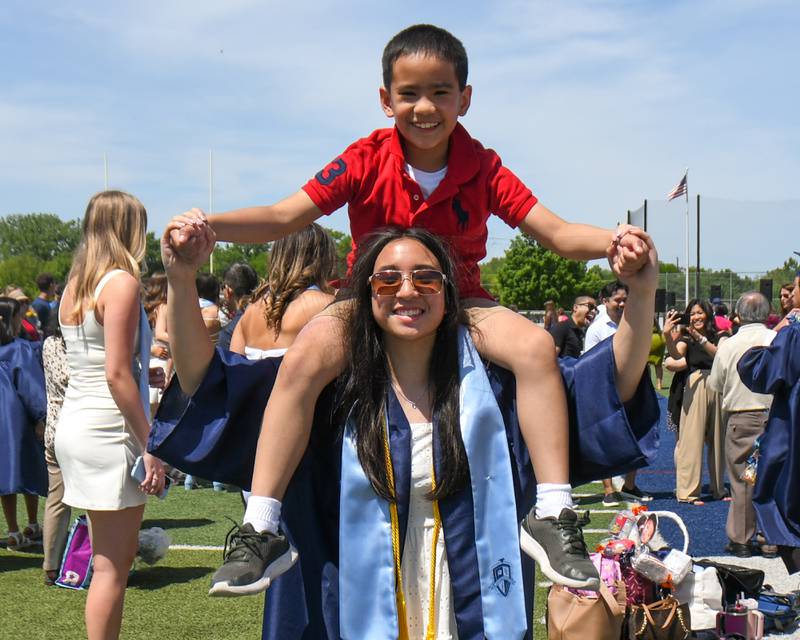 Downers Grove South graduate Elizabeth Rous and her 9-year-old brother Maximus Rous pose for a photo after the graduation ceremony held at Downers Grove South High School on Sunday May 19, 2024.