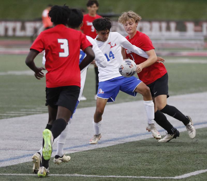 Larkin's Juan Cruz tries to control the ball between Huntley's Mathieu Tchoutan and Gavin Nixon during a nonconference soccer match on Thursday, Sept. 5, 2024, at Huntley High School.