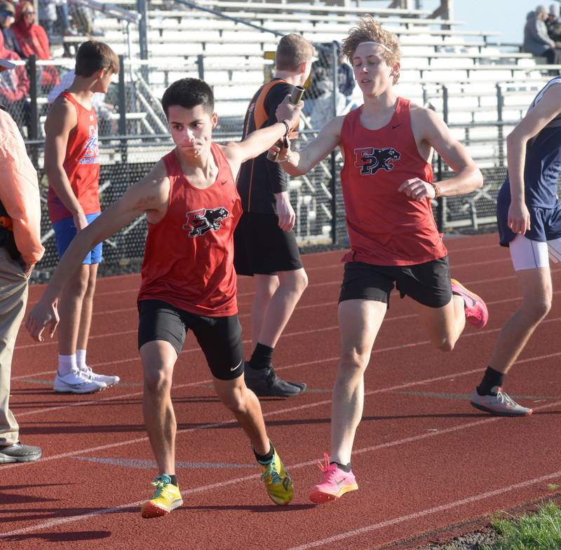 Erie-Prophetstown's Charlie Link hands the baton to Lucas Dreisback n the 4x800 relay at the Ed Schmidt Invitational Track Meet at Erie High School on Friday, April 19, 2024.