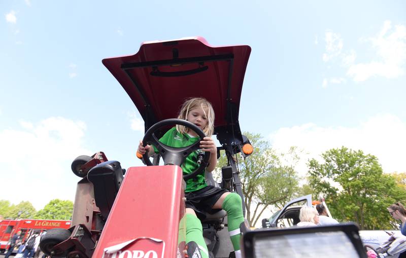 Meg Maley of La Grange tests the wheel and gears of a lawn mover during the La Grange Park District's Touch A Truck event held at Sedgwick Park Saturday May 11, 2024.