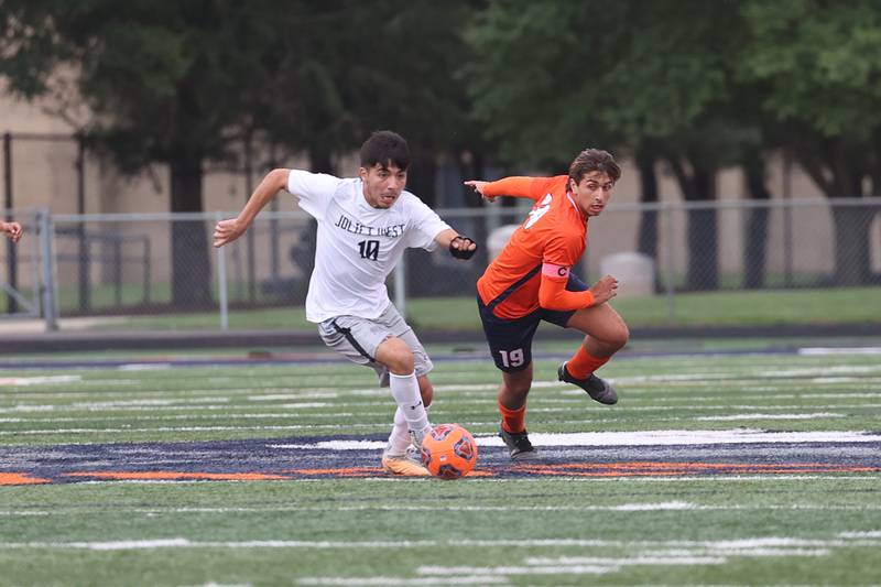 Joliet West’s Adrian Maldonado gets around Romeoville’s Gavin Carrasco on Wednesday, Oct. 11, 2023 in Romeoville.