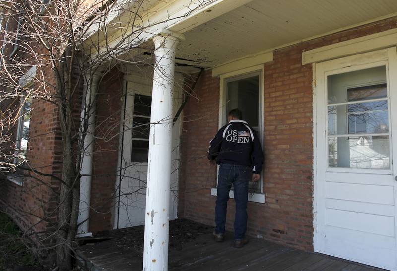 Tom Beestra looks over the property at his former home, the William H. Coventry House and Barn, on Thursday, April 23, 2015 at in Harvard. Landmark Illinois named the home as one of the 10 most endangered historic places in Illinois.