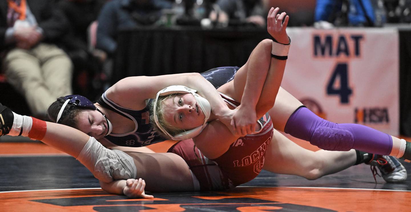 Lockport’s Claudia Heeney gets bent backward by Collinsville’s Taylor Dawson in the 130-pound bout at the girls wrestling state finals at Grossinger Motor Arena in Bloomington on Saturday, Feb. 24, 2024. Heeney won 4-2.
