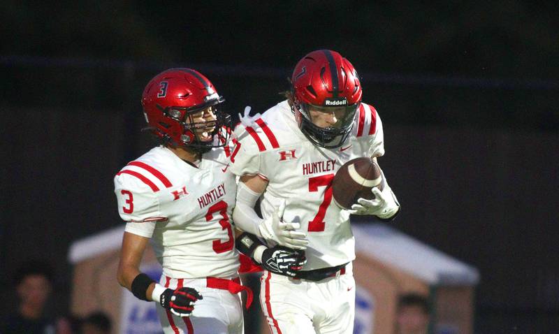 Huntley’s Wyatt Fleck, right, and Jordan Oruche celebrate a Fleck touchdown in varsity football on Friday, Aug. 30, 2024, at Metcalf Field on the campus of Crystal Lake Central High School in Crystal Lake.