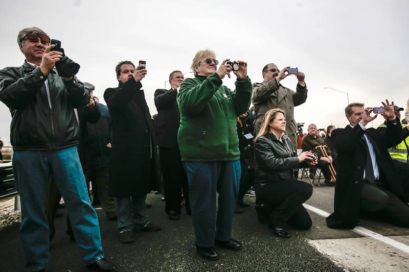 People take pictures of a ribbon cutting ceremony opening a westbound entry ramp onto Interstate-90 at the intersection of Illinois-47 in Huntley, Ill. on Friday. Lathan Goumas - lgoumas@shawmedia.com