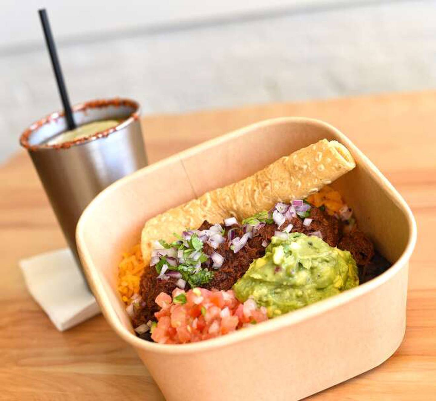 Guisados at Sweetchilango can be served as tacos, enchiladas or platas as pictured. This one features birria on a bed of red rice with black beans, guacamole, pico de gallo and a housemade tortilla.