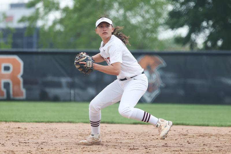 Lincoln-Way Central’s Isabella Olmos looks to make a throw to first against Lincoln-Way West on Tuesday, May 14, 2024 in New Lenox.