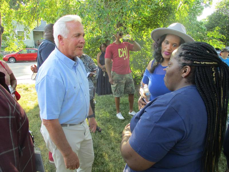 Mayor Terry D'Arcy expresses his condolences to Tysha Hammond before a vigil on Friday, June 2, 2023 for her son, Antoine Shropshire, who was killed by gunfire in Joliet three nights earlier.