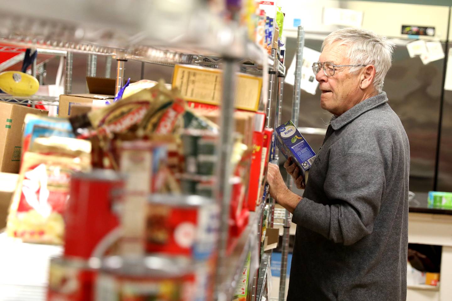 Volunteer John Weigand of Batavia stocks shelves at the Batavia Interfaith Food Pantry and Clothes Closet.