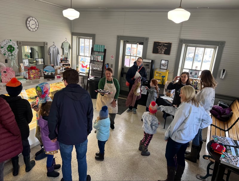 Customers gather inside Springview Sweets Bakery during a brownie giveaway by Realtopia Real Estate. Proceeds from the bakery during the event benefitted Lupine Montessori School.